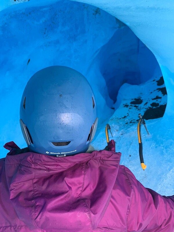  Climber going into a snow cave with Chugach Adventure Guides 