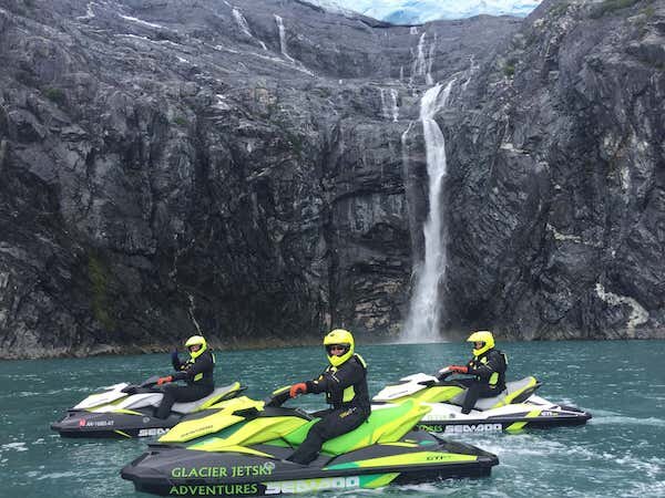  Jet Ski Riders next to waterfall  