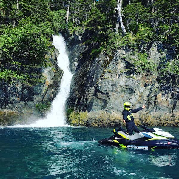  A jet ski rider next to a waterfall on a tour with Glacier Jet Ski Adventures 
