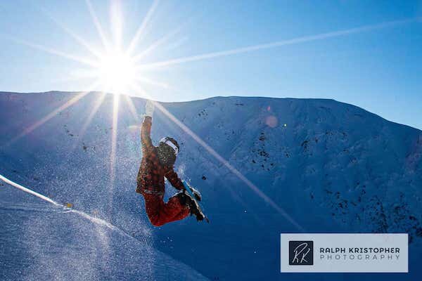  A snowboarder flying in the air on Alyeska Mountain  photo by Ralph Krisopher Photography 