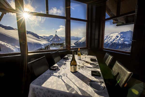  a five top table overlooking the mountain views at the Seven Glaciers Restaurant  