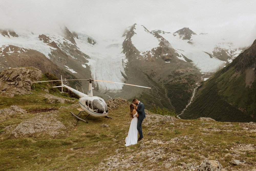  A couple enjoying a wedding at the base of a glacier by Seward Helicopter Tours  