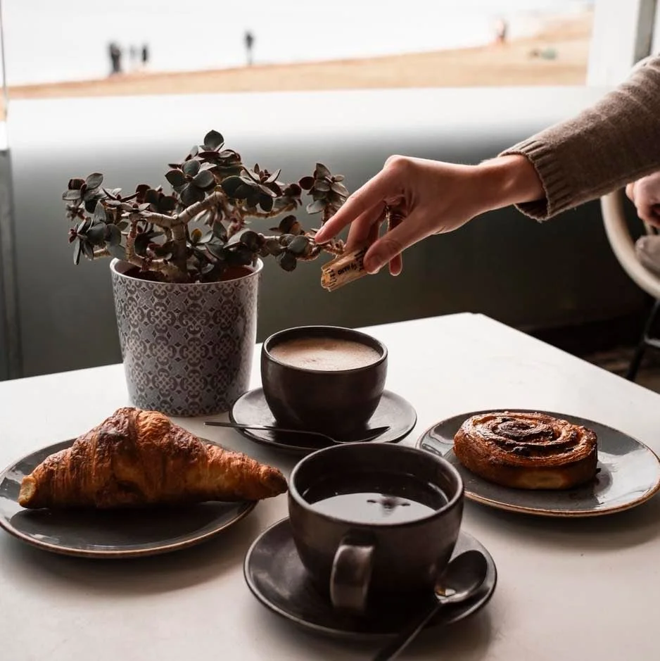 Not every beach day needs sunshine - just a warm drink, fresh pastries, big breakfasts and the sound of rain meeting the sea. Moody skies, cosy vibes, and coffee that hits just right ☕🌊

Open everyday from 9am, we&rsquo;ll see you then 🫶🏼
