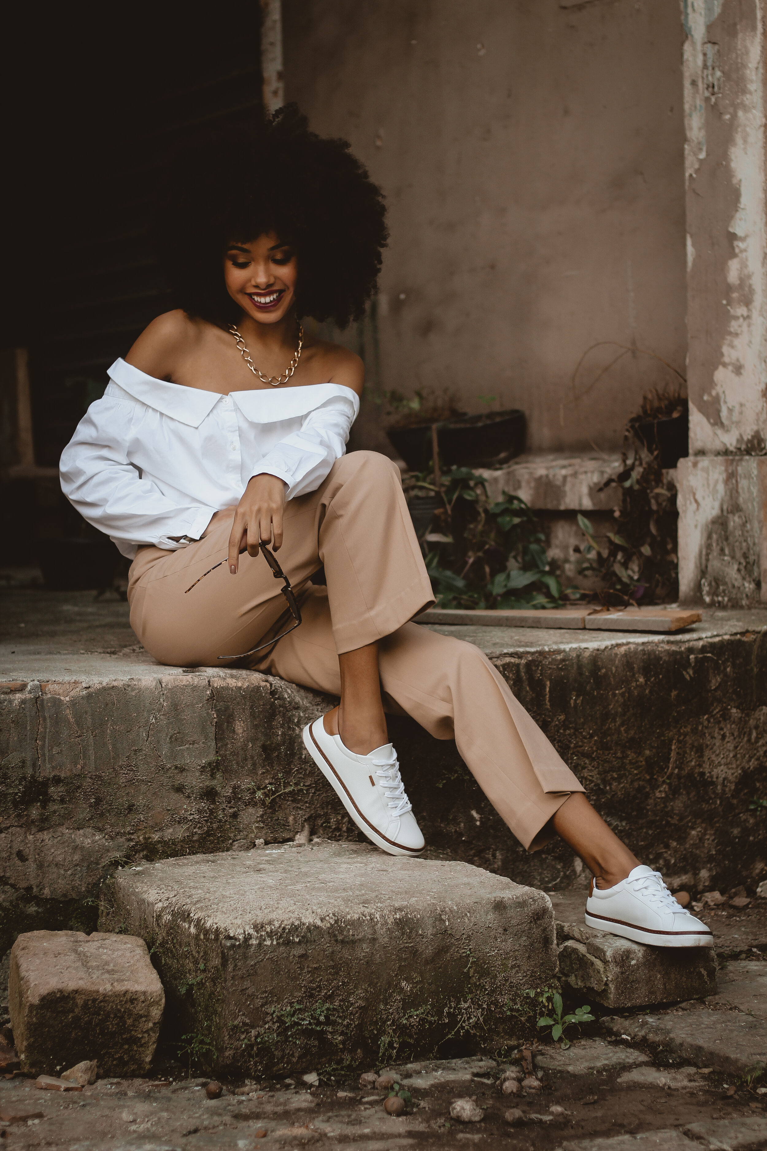 photo-of-smiling-woman-sitting-on-concrete-block-posing-2873674.jpg