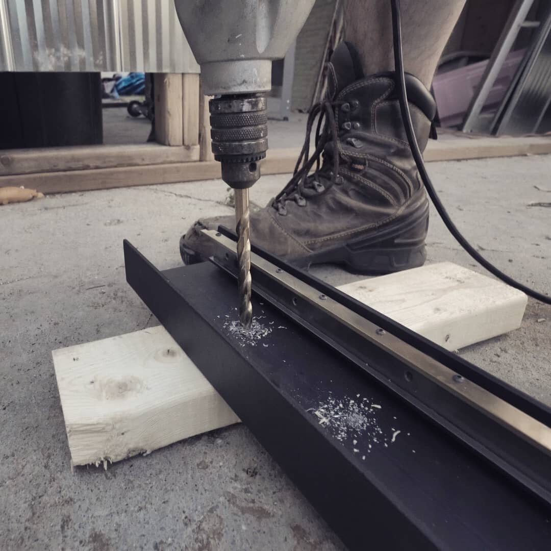 Drilling 1/2&quot; holes for mounting the c-channel on the wall. This has to be done on site so that we could measure exactly where the studs were for mounting.

#architecturaldetails #architecturalfabrication #customarchitecture #metalworking #archi