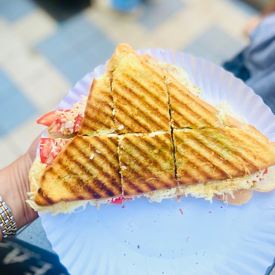 No trip to the beautiful Mumbai neighborhood of Santacruz is complete without a stop at @Sandwizza! Scroll &mdash;&gt; to take a look. Against a backdrop of their for-sale secret sandwich masala up top, only two people work the line&mdash;one assembl