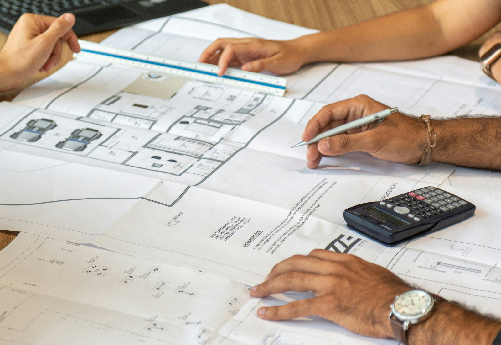 Project team reviewing architectural plans during permit coordination