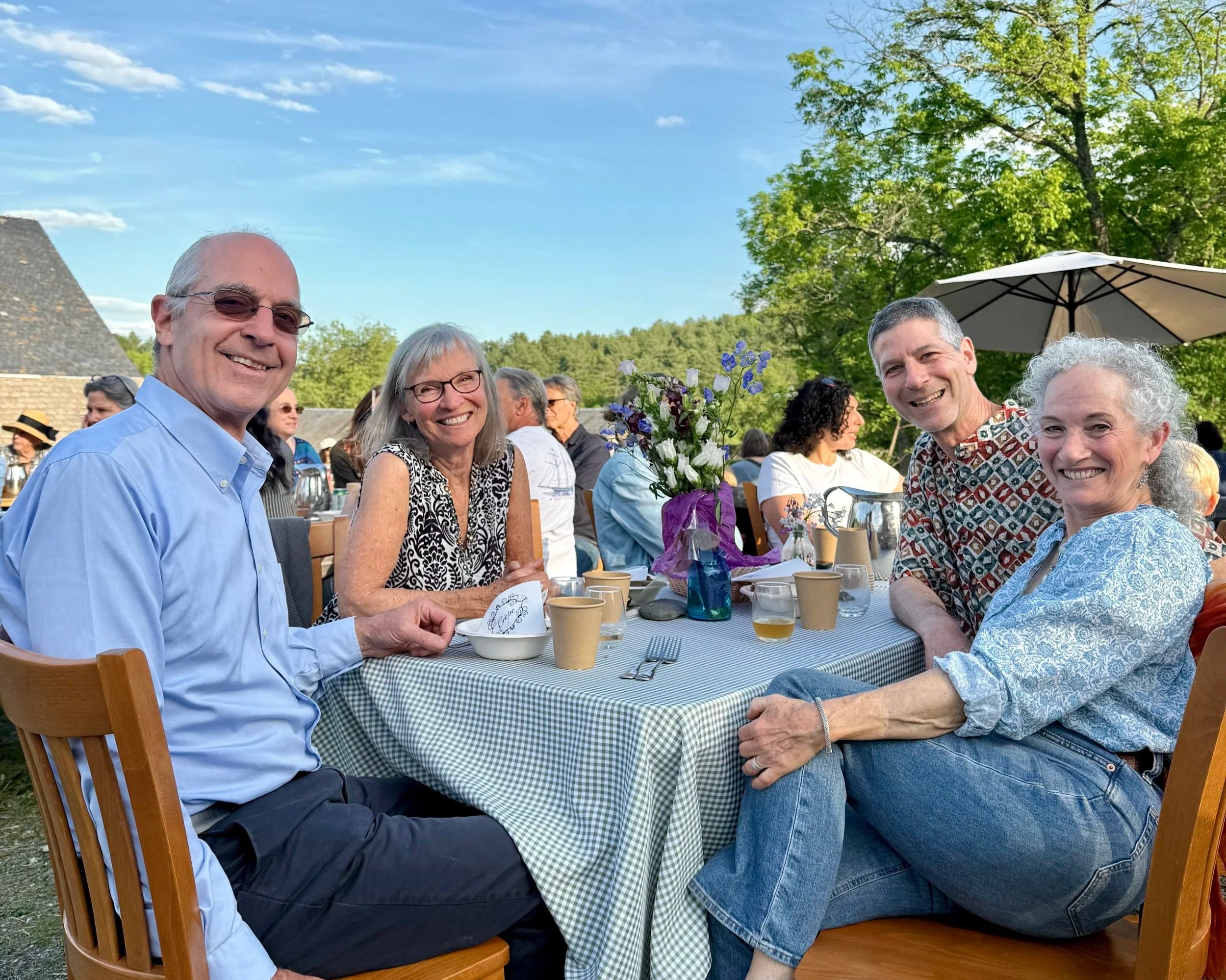 smiling families at picnic tables eating crepes