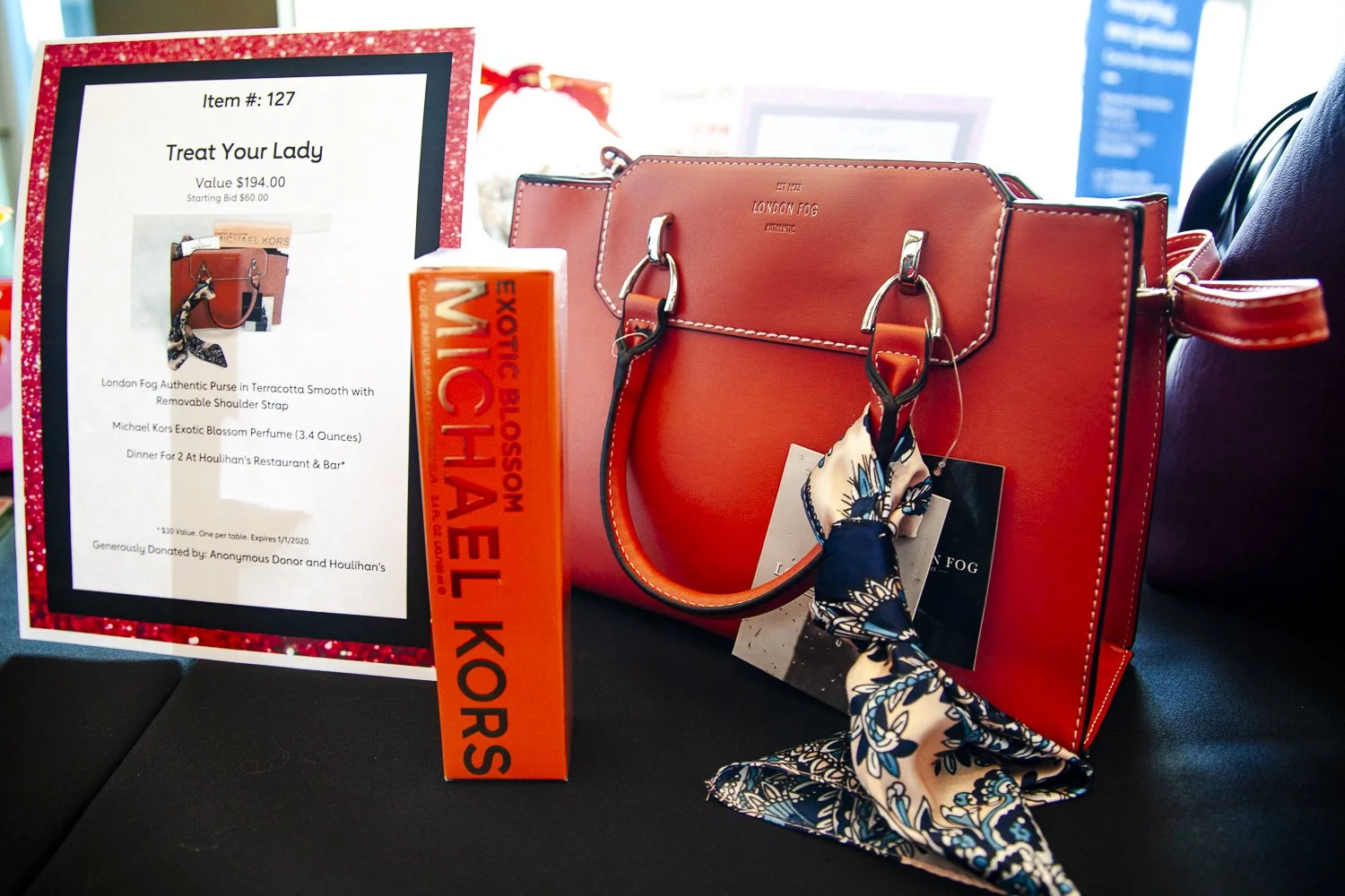 Auction item photography of luxury accessories and fragrance using mixed lighting conditions. Controlled exposure and perspective to clearly document brand markings, materials, and condition for high-volume event listings.