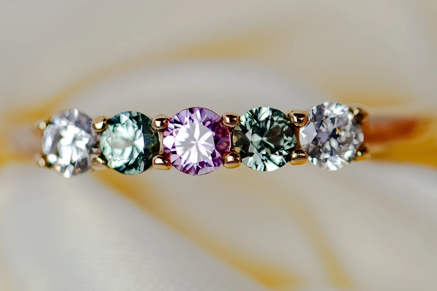 Close-up jewelry photography using diffused natural light to accurately render metal tone, gemstone color, and fine detail. Emphasis on clarity, focus precision, and reflective surface control.