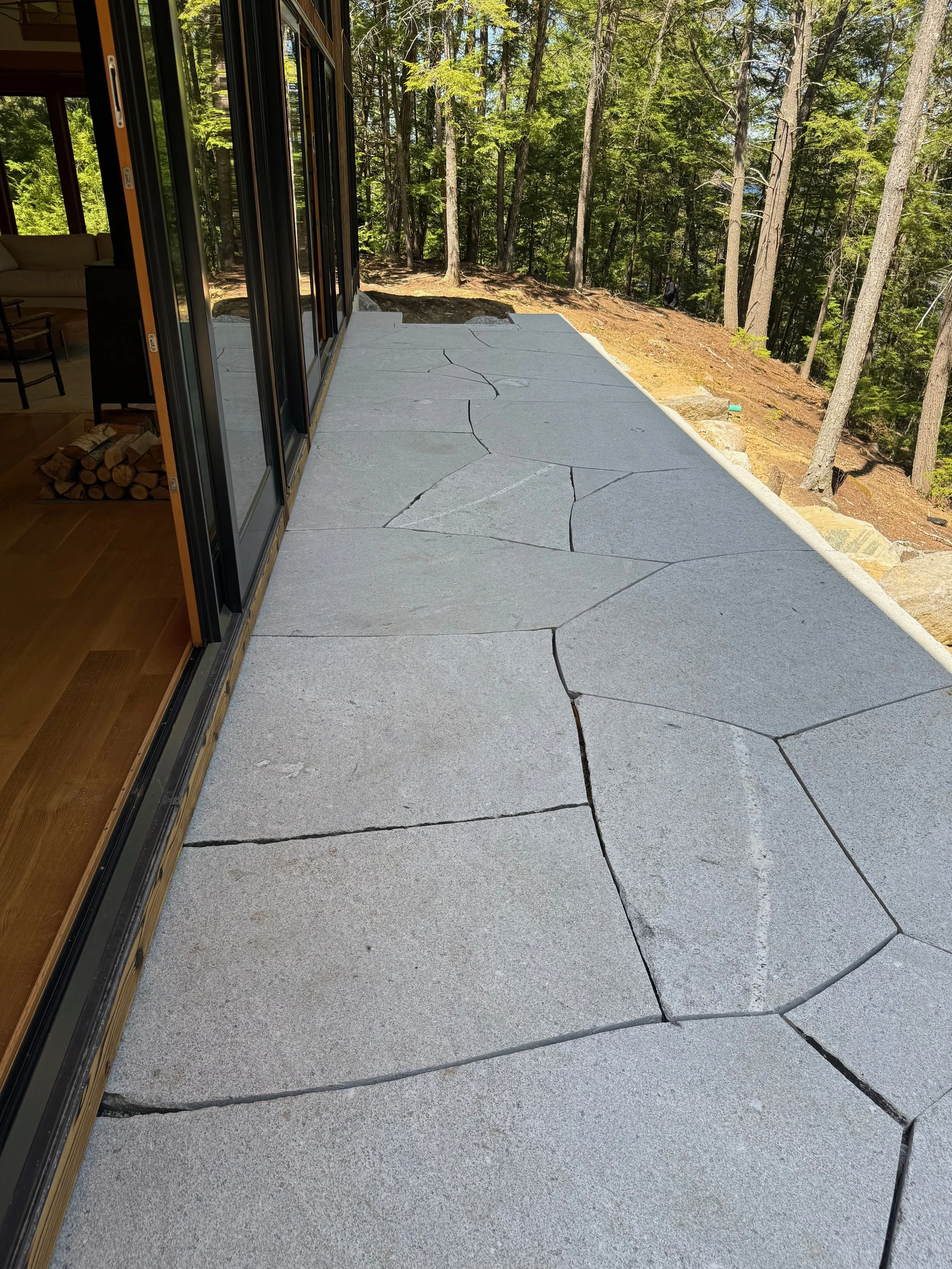 Patio made from large granite flagging with thermal finish