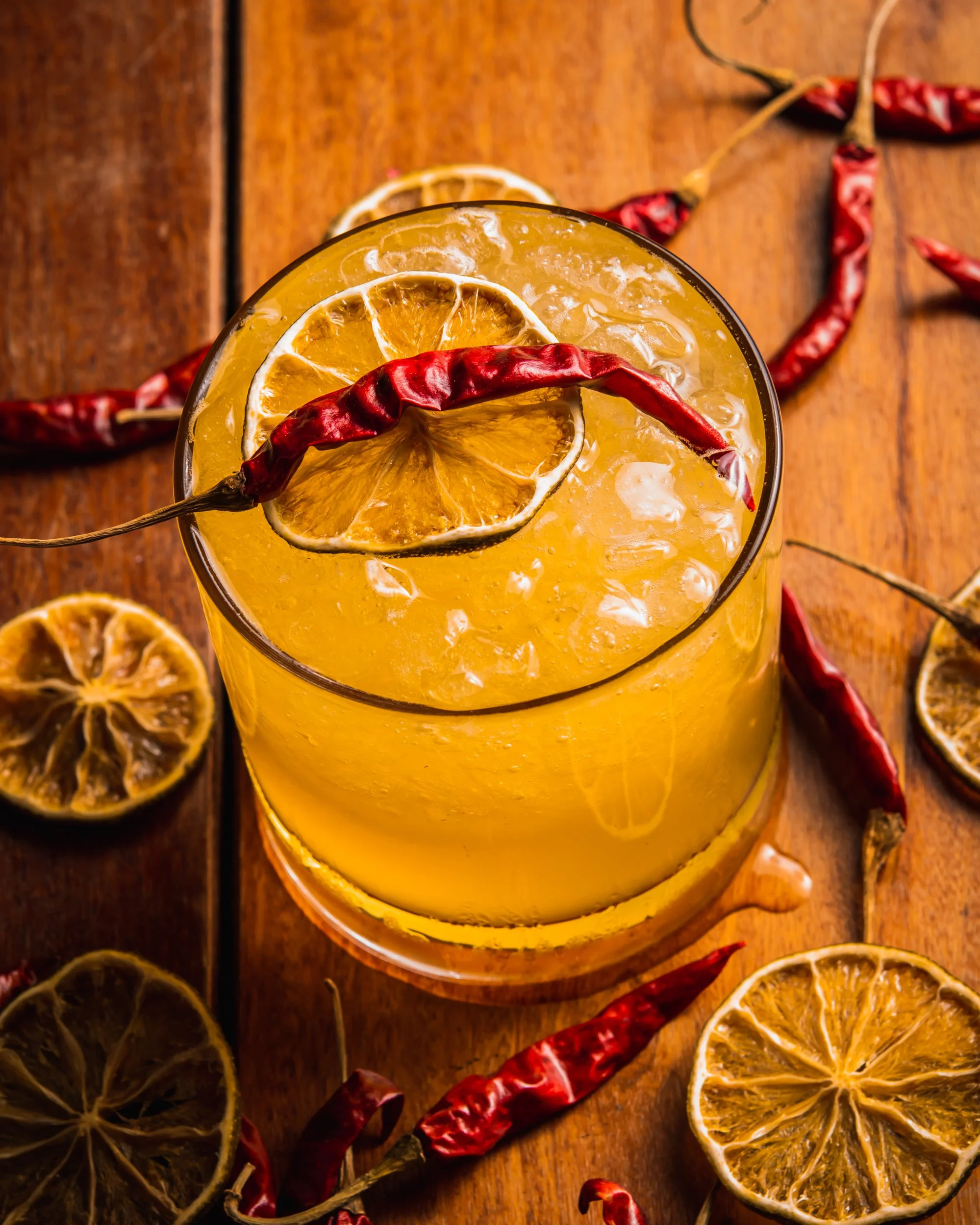 Spicy passionfruit cocktail garnished with dried chili and citrus, photographed for 1-800 Lucky in Wynwood.