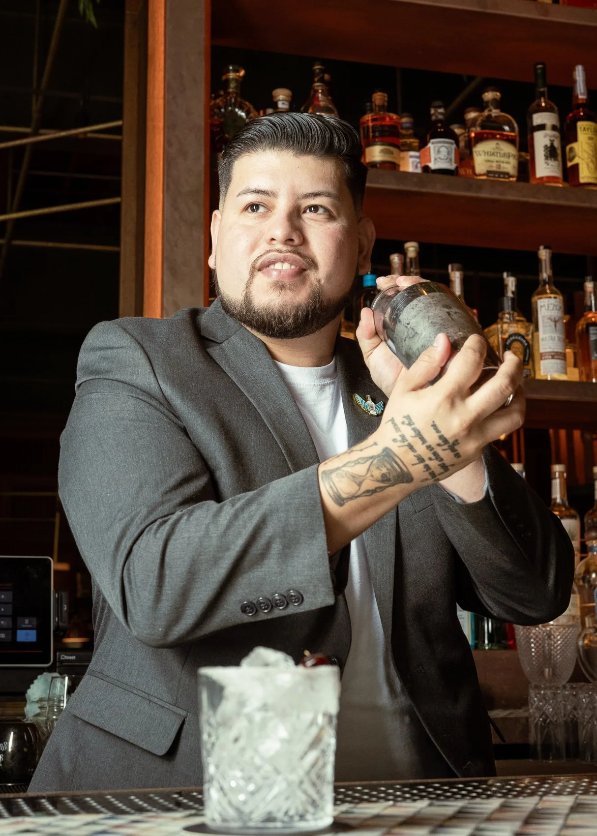Professional bartender portrait of Fabio Crista shaking a cocktail at the bar, photographed for his events bartending brand Avalon Vibes in Miami.
