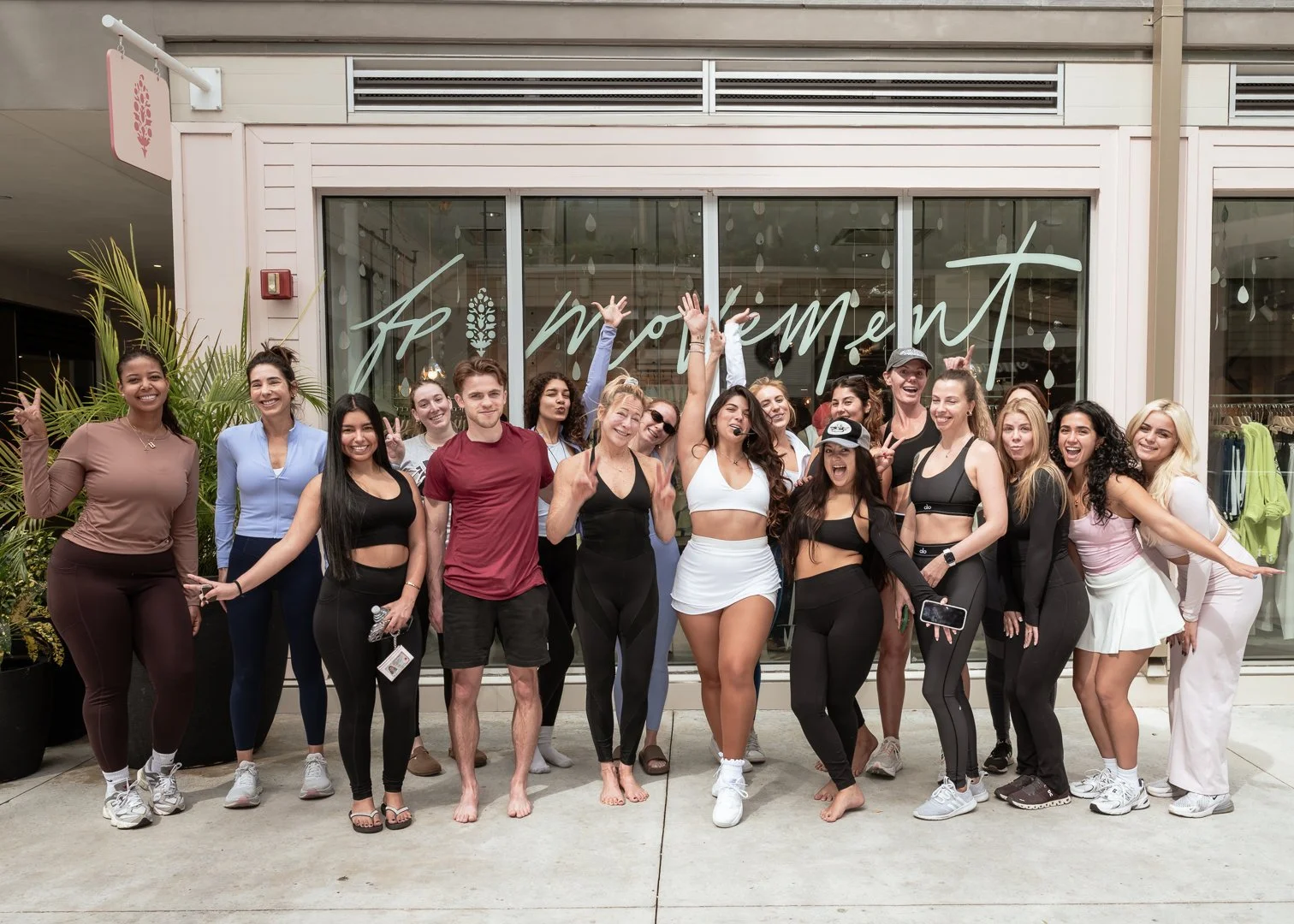 Group photo of participants at the Cocowalk Plaza morning yoga flow led by Jaqueline Fiol, hosted in collaboration with Mimi Yoga and FP Movement.