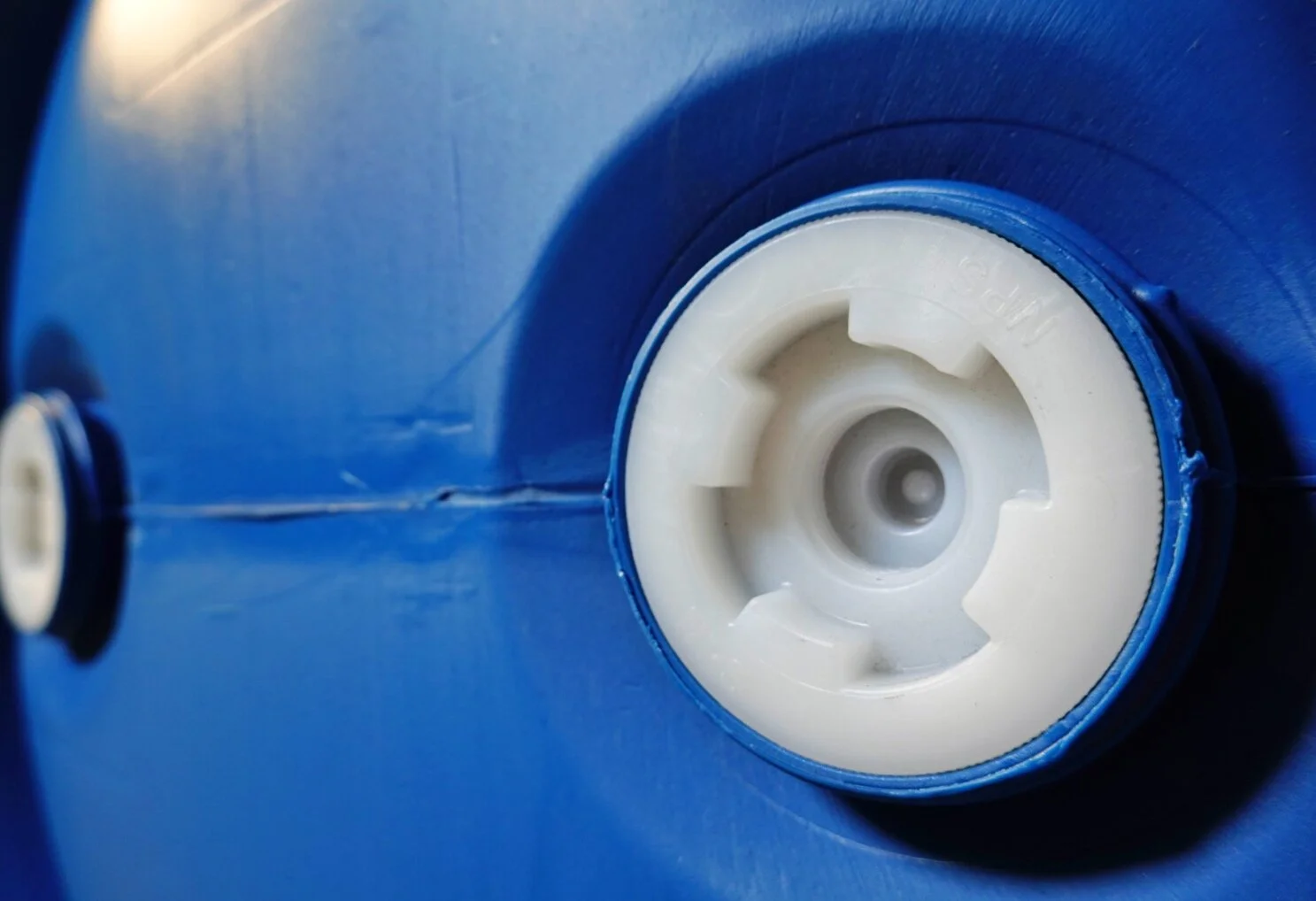 Close-up of a blue plastic container with a white screw cap