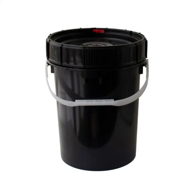 A black plastic bucket with a white handle and a red vent on the lid