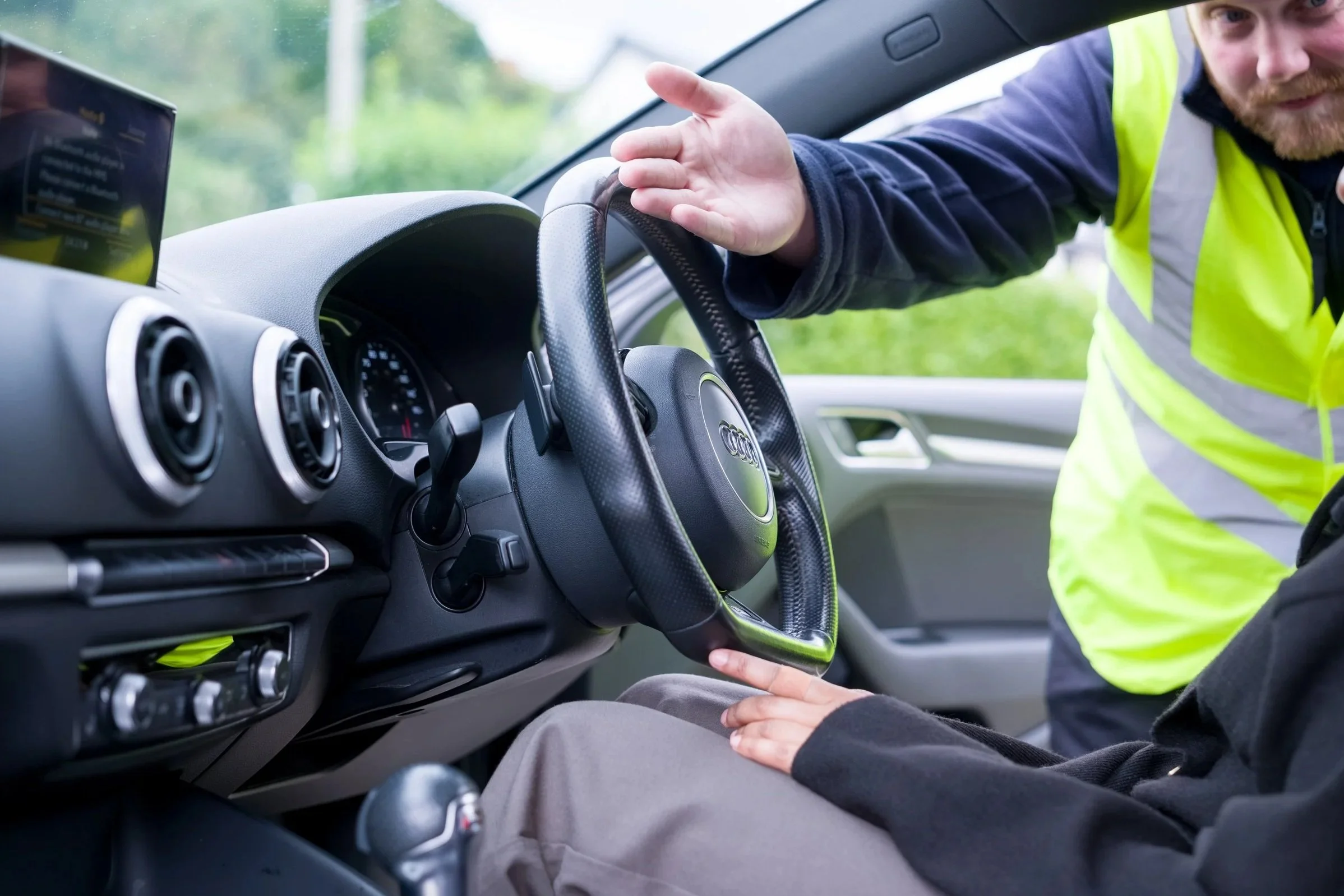 Car interior being used to demonstrate the vehicle’s features to a buyer or seller