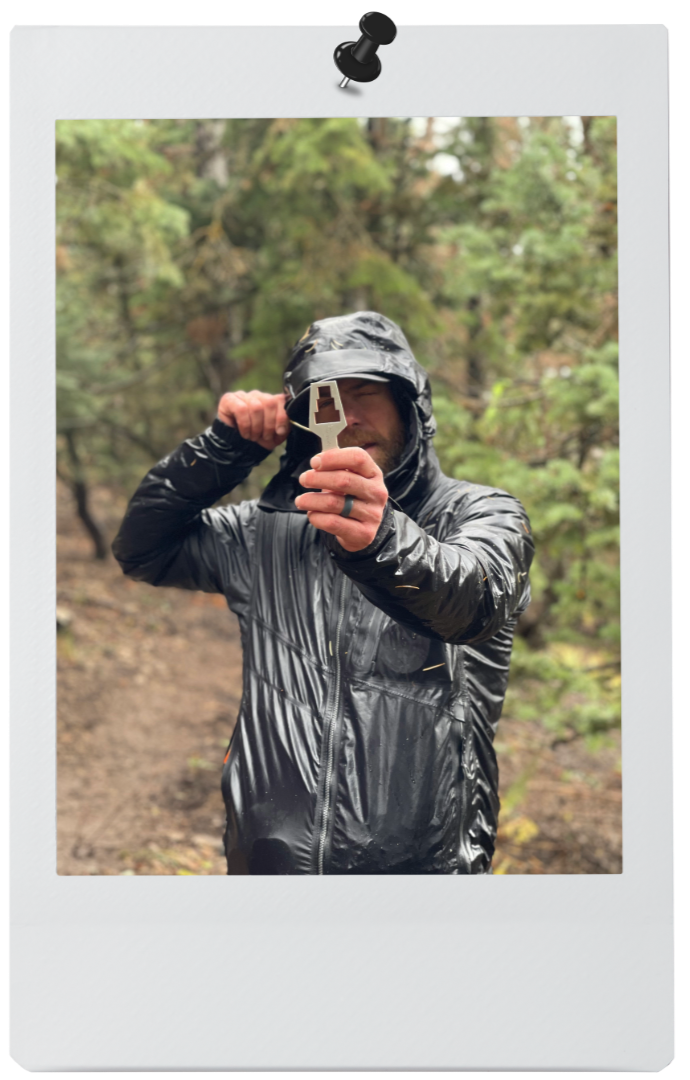 Man in the field with tool looking through to viewer