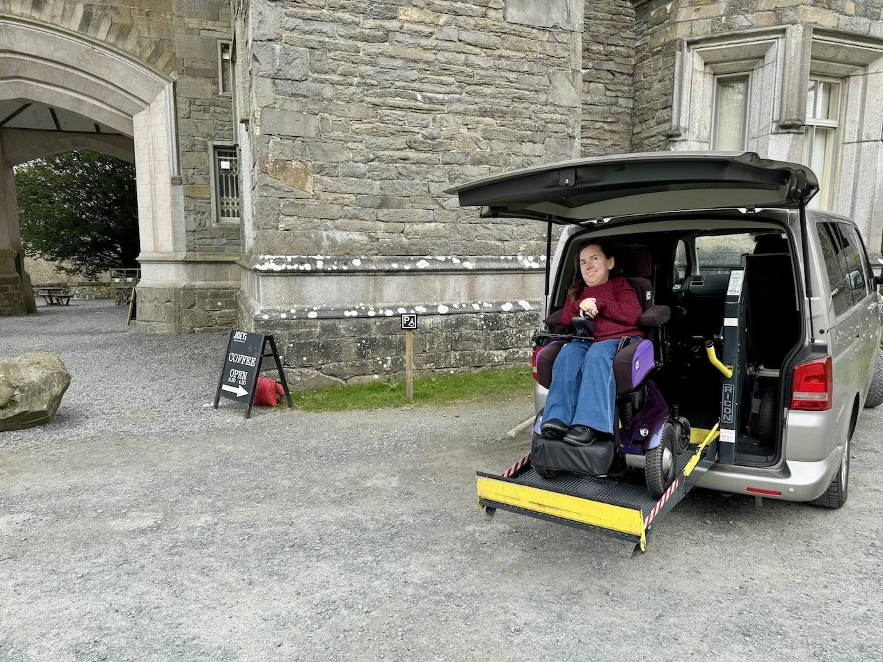 A wheelchair user exiting her VW Transporter, demonstrating the Blue Badge parking and accessibility at National Trust Wray Castle 
