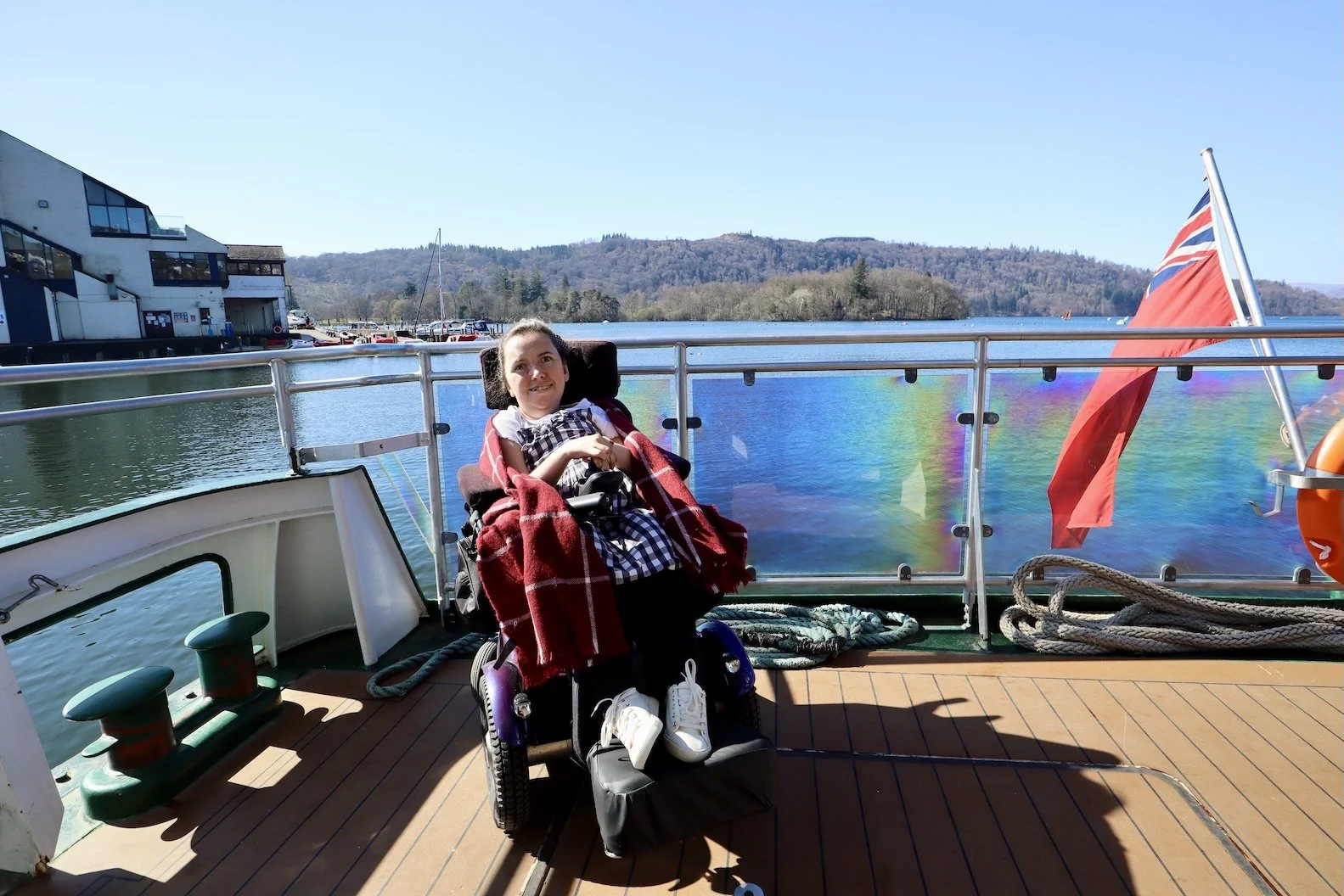 A wheelchair user on the outer deck of the MV Swift wheelchair accessible boat by Windermere Lake Cruises 