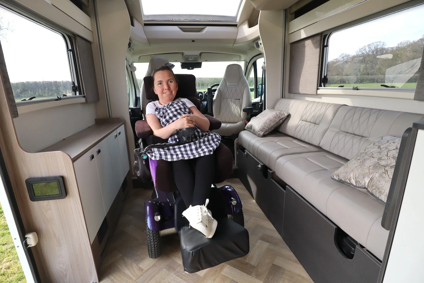  Karla, sitting in a wheelchair accessible motorhome in her powerchair 