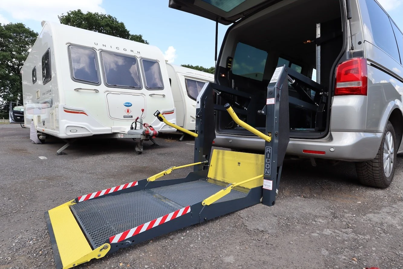  A hydraulic wheelchair lift is deployed from the rear of a wheelchair accessible Volkswagen Transporter 