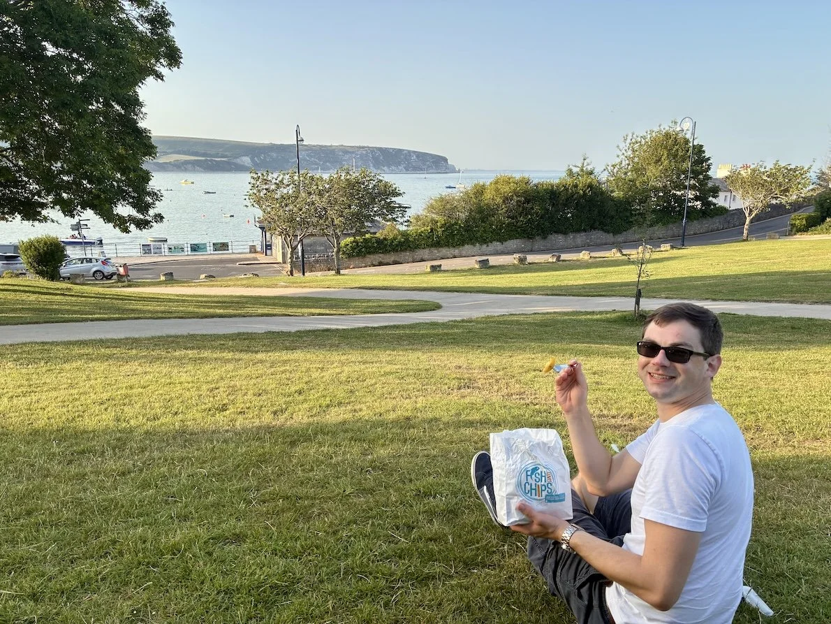 Stephen eating fish and chips in Prince Albert Gardens in Swanage