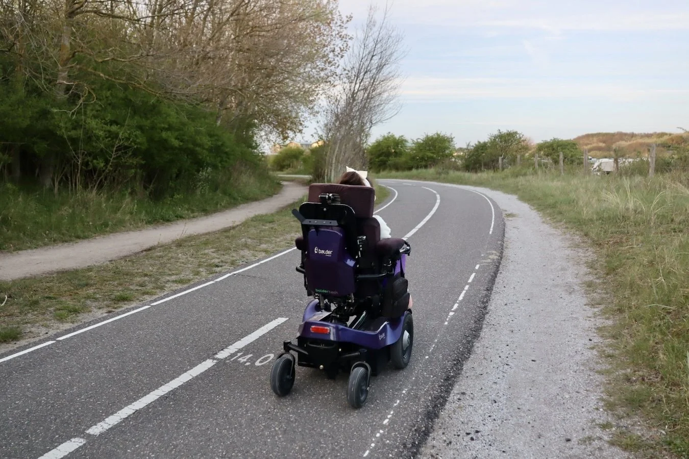 Karla in her Balder electric wheelchair on a cycle path in The Netherlands