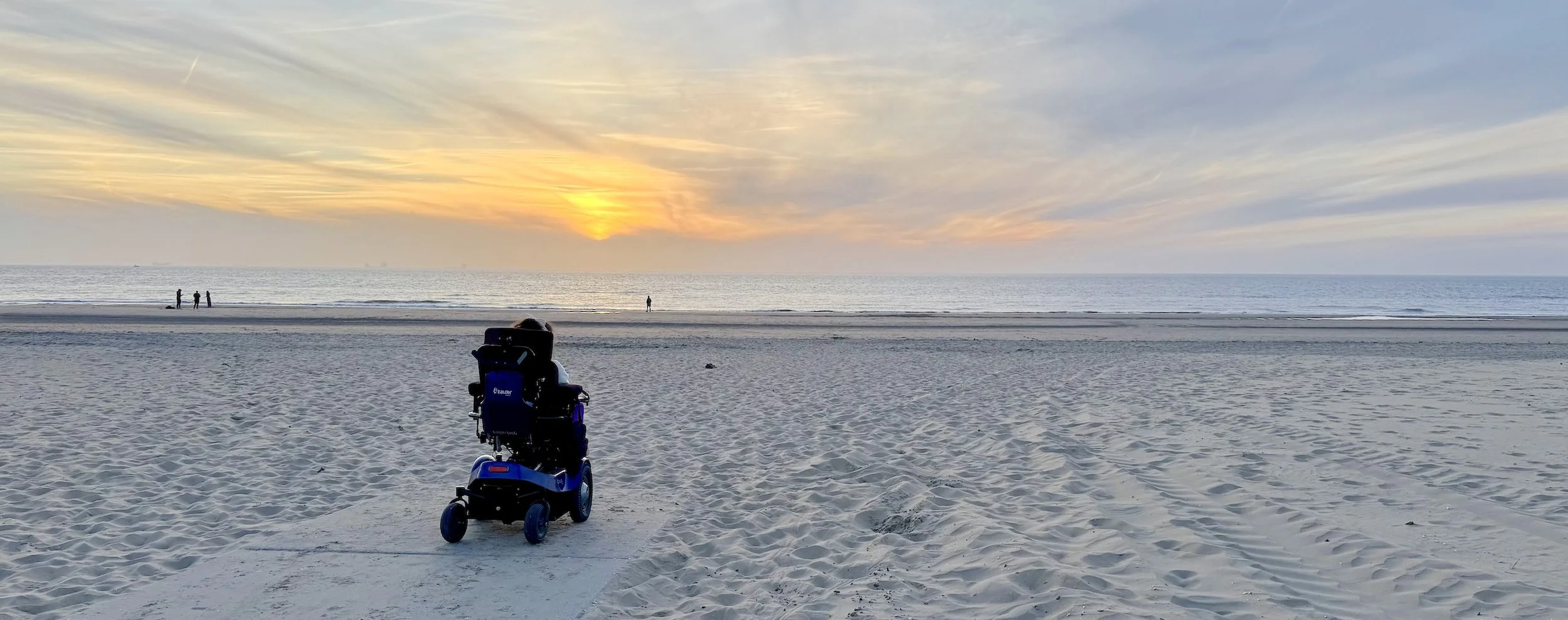 Karla in her Balder electric wheelchair on an accessible beach at Katwijk aan Zee in the Netherlands