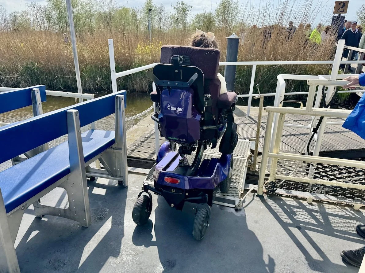 Karla in her Balder electric wheelchair leaving the boat at Werelderfgoed Kinderdijk in the Netherlands