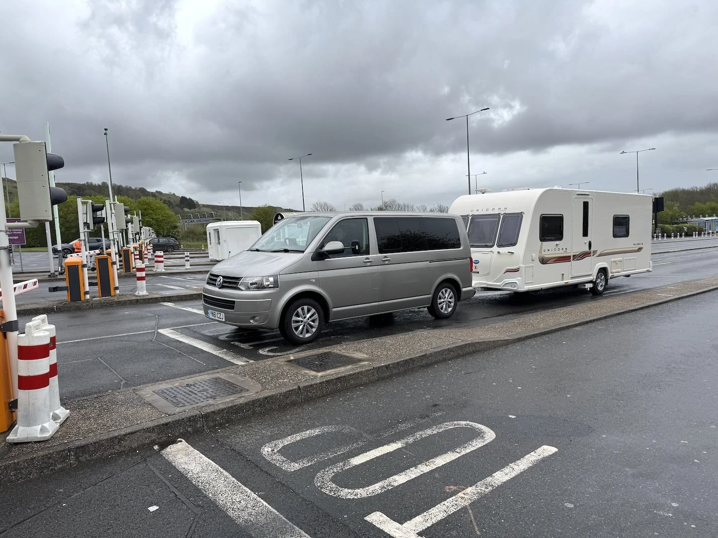 A VW Transporter towing a Bailey Unicorn Valencia touring caravan, waiting to board Le Shuttle