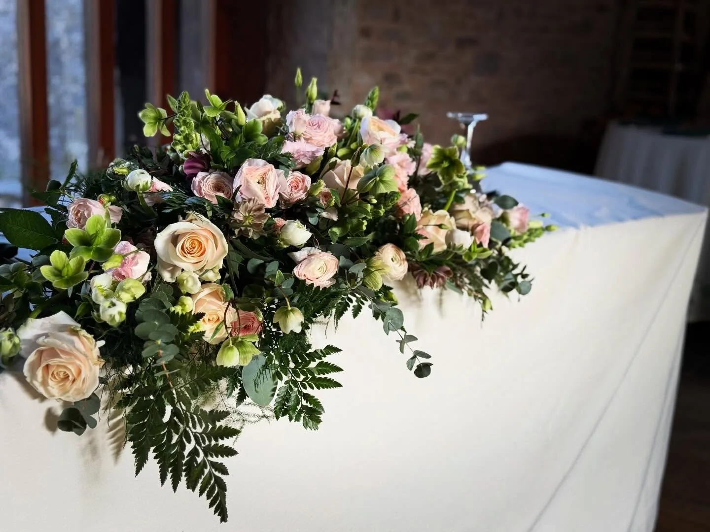 A statement piece that does it all 🤍🌿

This romantic top table arrangement is designed to bring softness, elegance, and a natural flow to your wedding setting. Featuring delicate blush tones, lush greenery, and layered textures, it creates a beauti