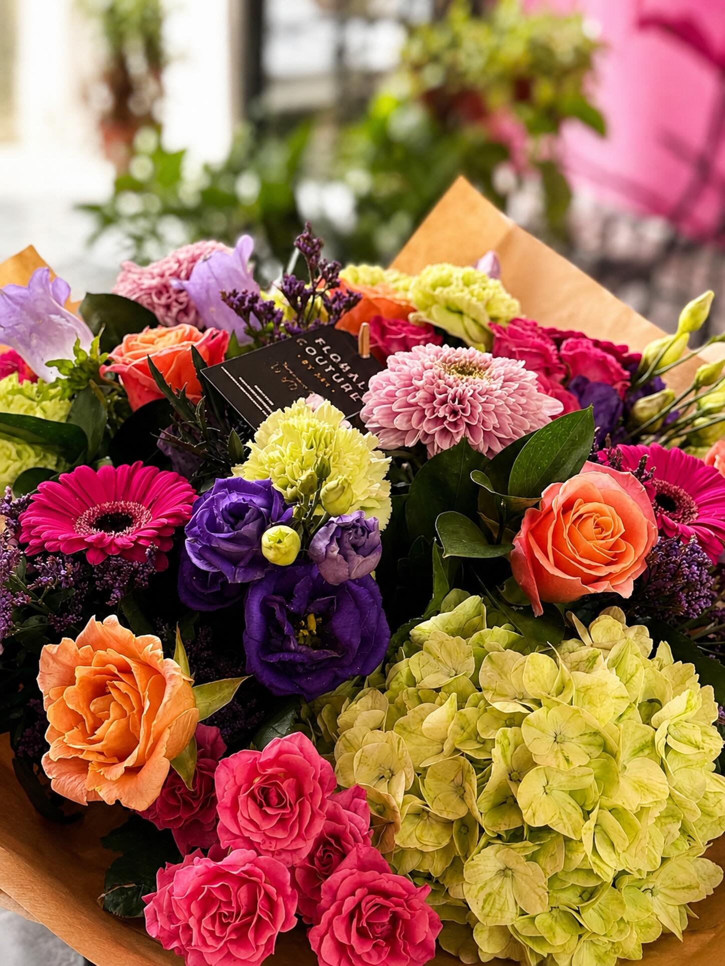 Bold blooms, soft textures, and a whole lot of love wrapped into one bouquet 💐✨

This custom arrangement features vibrant roses, hydrangeas, gerberas, lisianthus, and seasonal florals in a playful mix of pinks, peaches, purples, and fresh greens &md