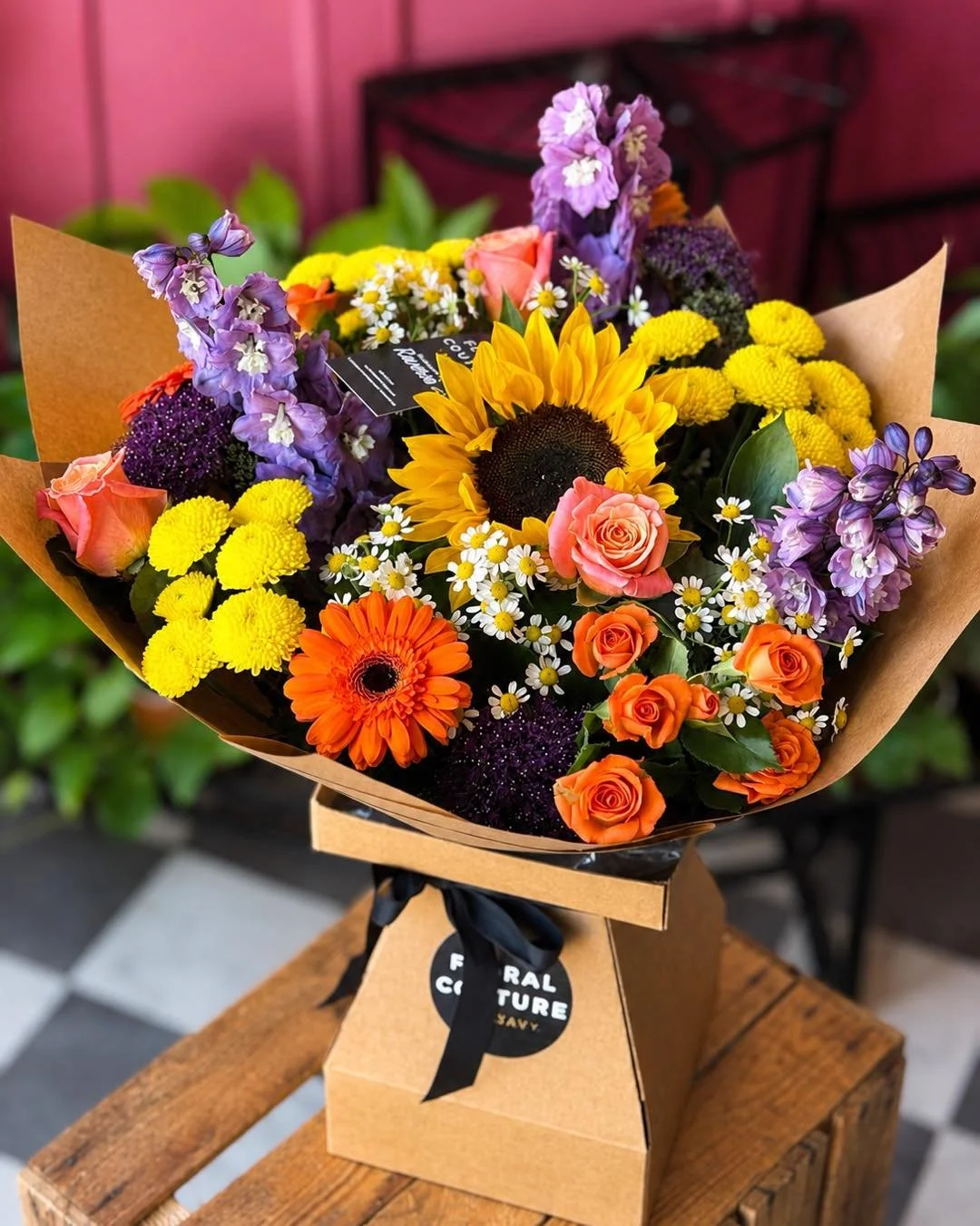 🌻 A bouquet full of sunshine and smiles! 🧡💜
Bursting with vibrant sunflowers, orange roses, gerberas and seasonal blooms, this hand-tied bouquet is perfect for celebrating life&rsquo;s special moments&mdash;or simply making someone&rsquo;s day.

?