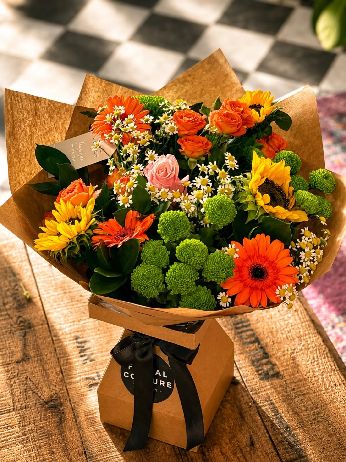 ✨ Sunshine wrapped in blooms. ✨

This vibrant hand-tied bouquet is bursting with golden sunflowers, radiant orange roses, cheerful gerberas, and fresh green button chrysanthemums&mdash;designed to brighten someone&rsquo;s day from the moment it&rsquo