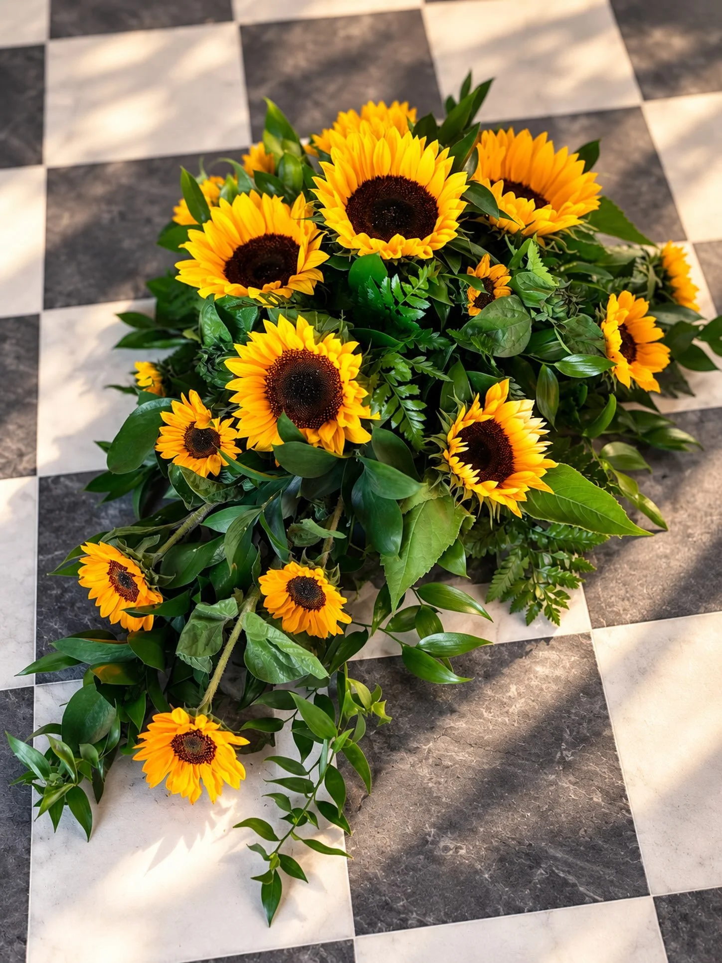 🌻 A beautiful celebration of sunshine and love 🌻

This striking single-ended spray was created with gorgeous, vibrant sunflowers surrounded by an abundance of rich greenery. 💛🌿

Sunflowers bring such warmth to a farewell tribute &mdash; their bol