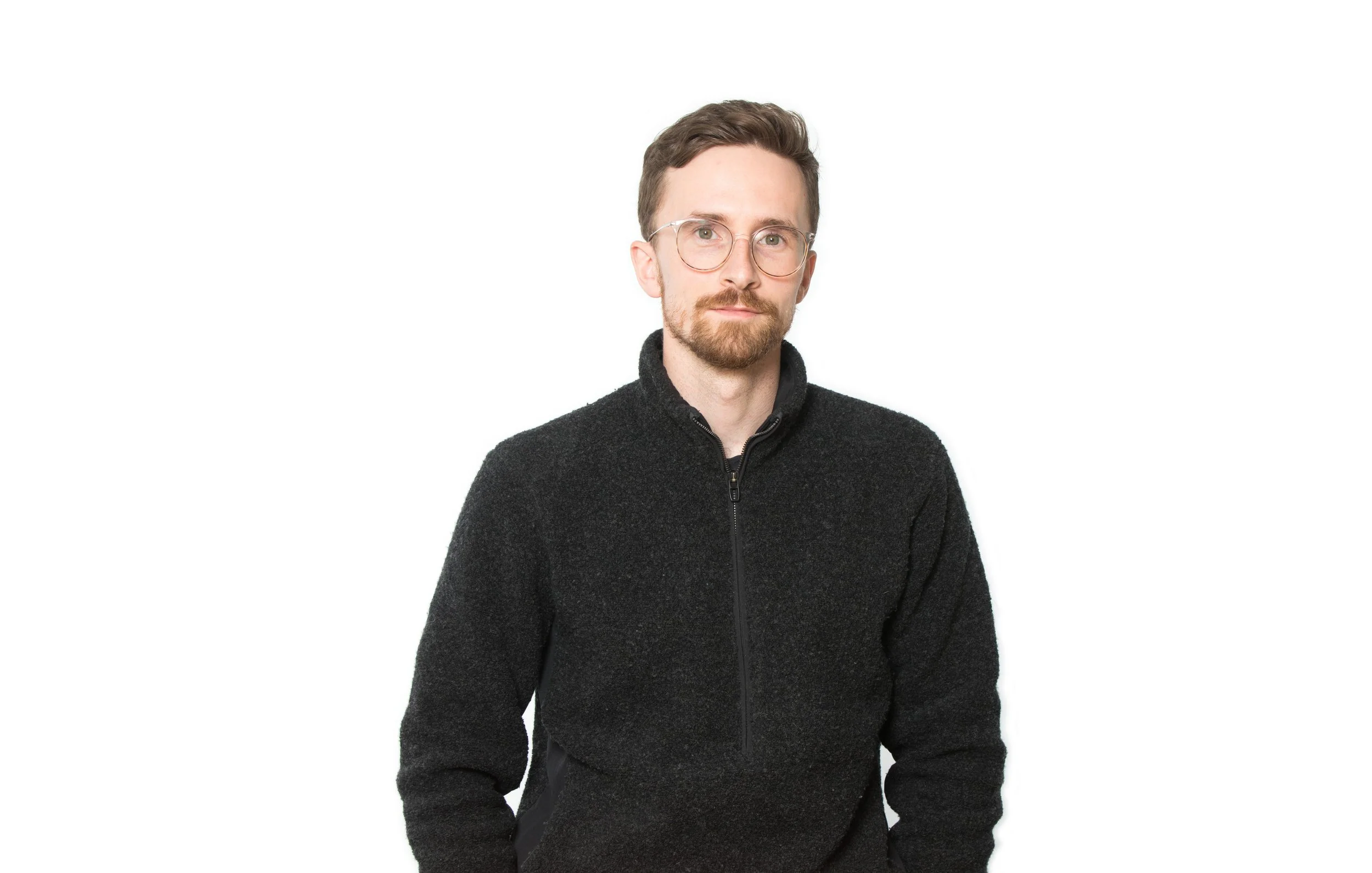 Person wearing black sweater on white background