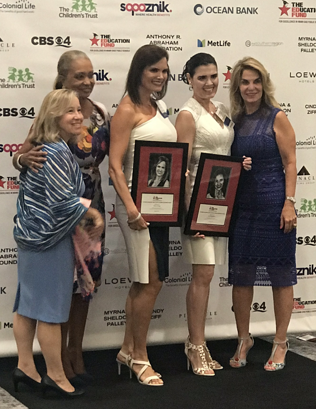 Ana and her sister, Monica Veiga, receiving recognition as successful alumni of Miami Dade Public Schools.