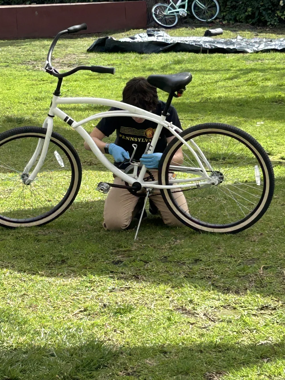 A young mechanic works on a bike