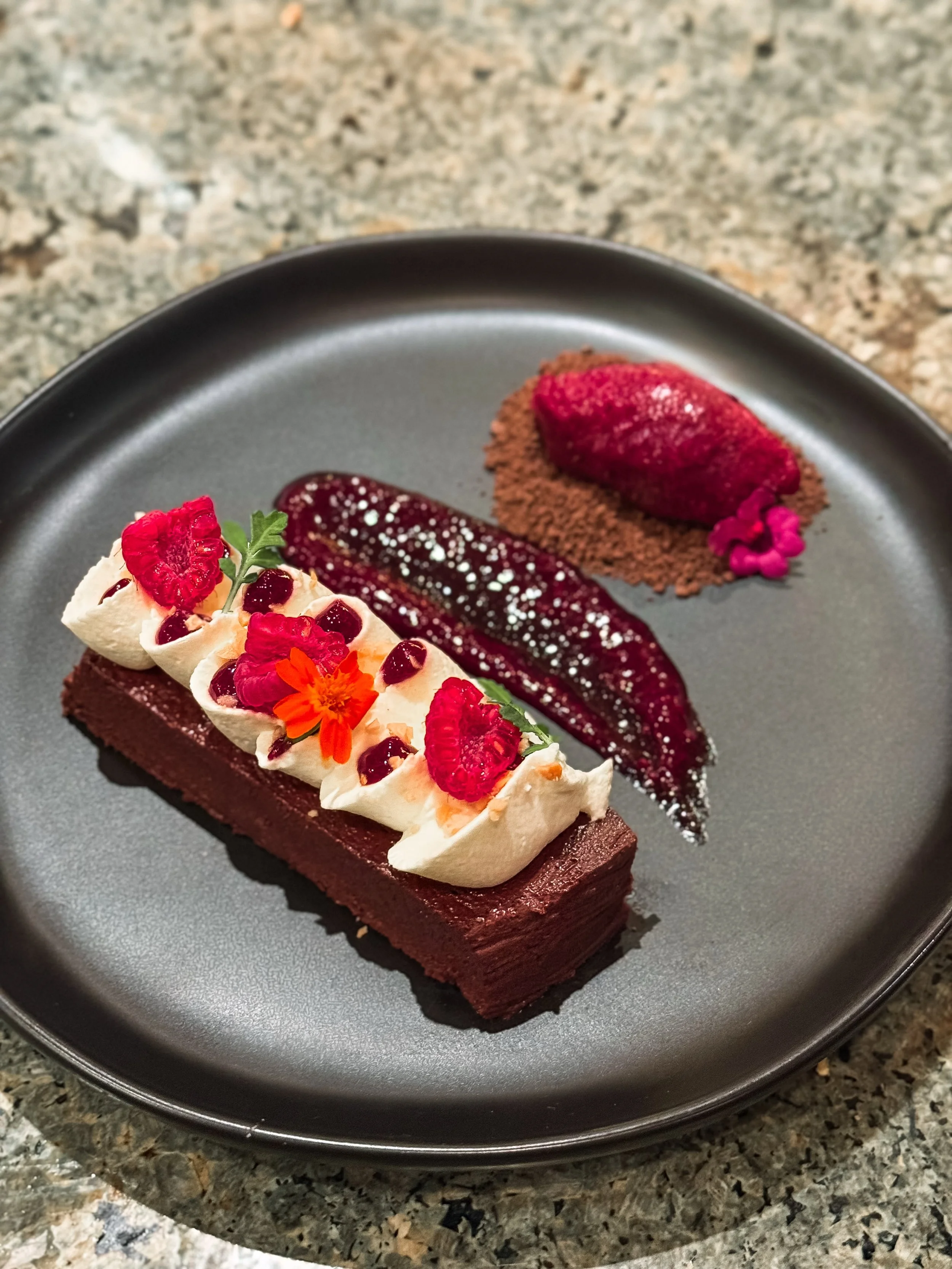 DARK CHOCOLATE TERRINE
raspberry sorbet | chocolate sand | raspberry compote | toasted almonds

Dark chocolate and raspberry is one of those combinations that never stops feeling timeless. Rich dark chocolate paired with cold raspberry sorbet, tart c