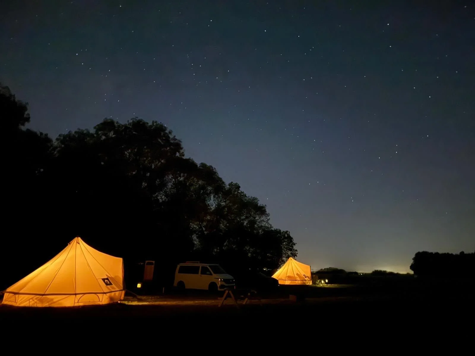 Our bell tents pictured at night - so cosy!