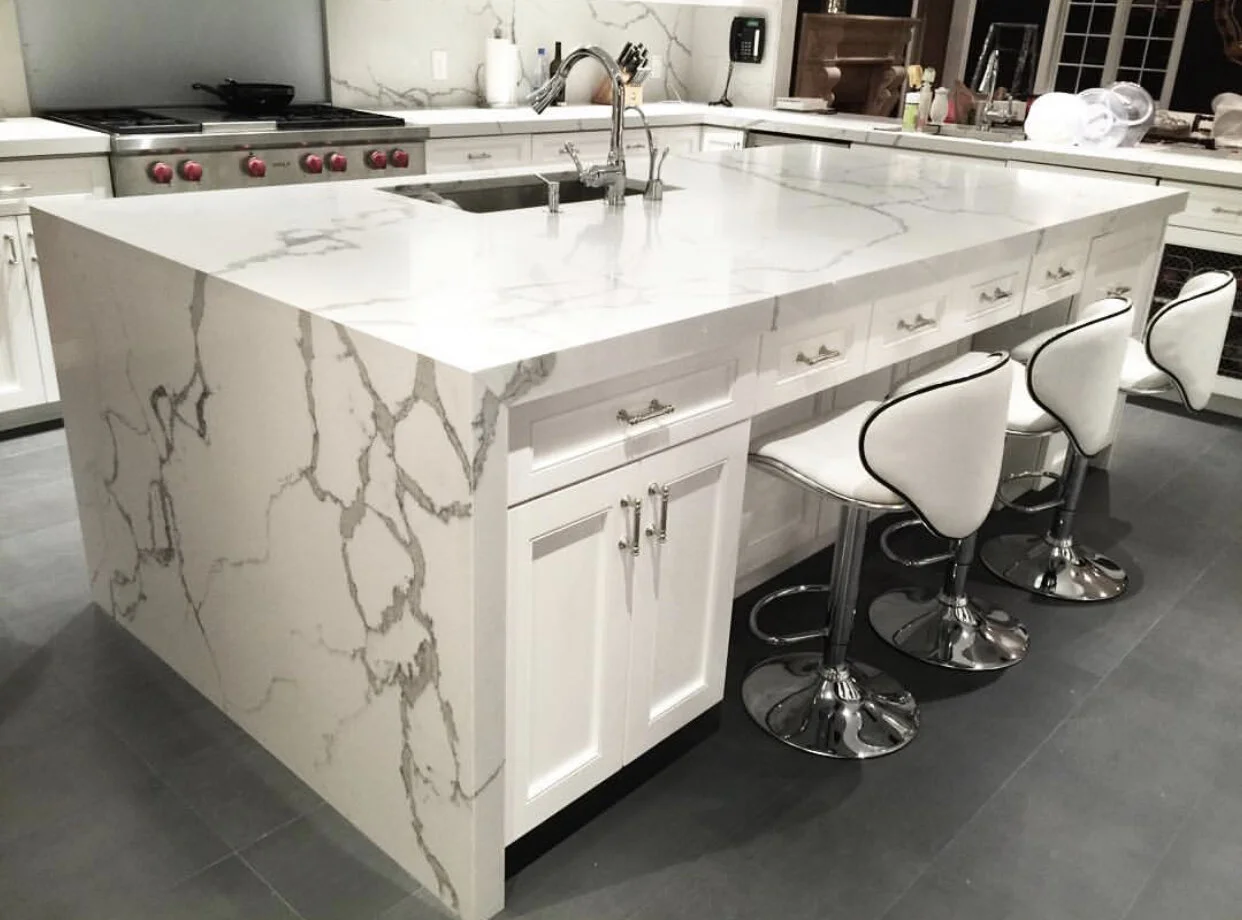 White marble waterfall kitchen island by Intermarble in Port Washington, New York