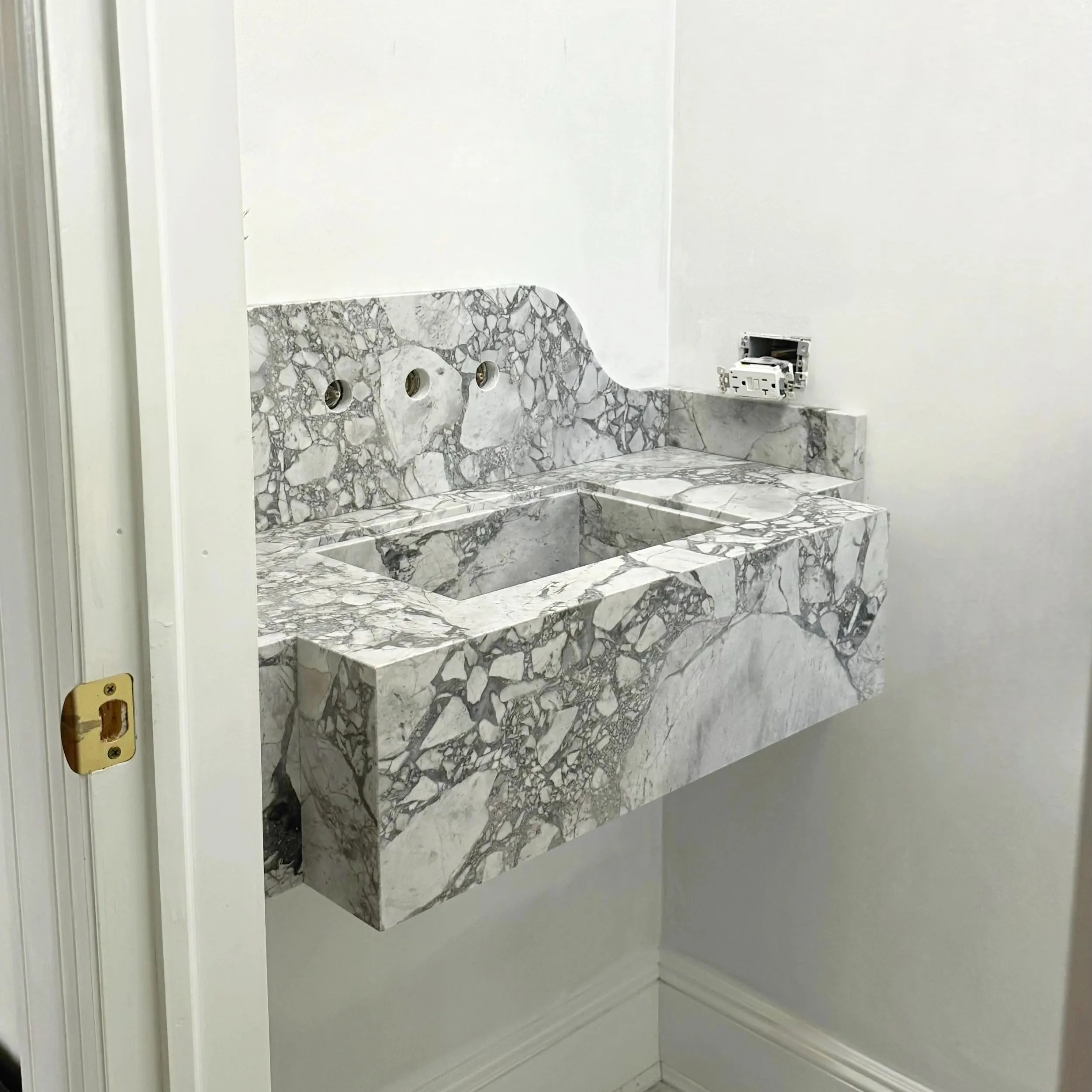 Custom marble integrated sink and floating vanity by Intermarble in Nassau County, NY