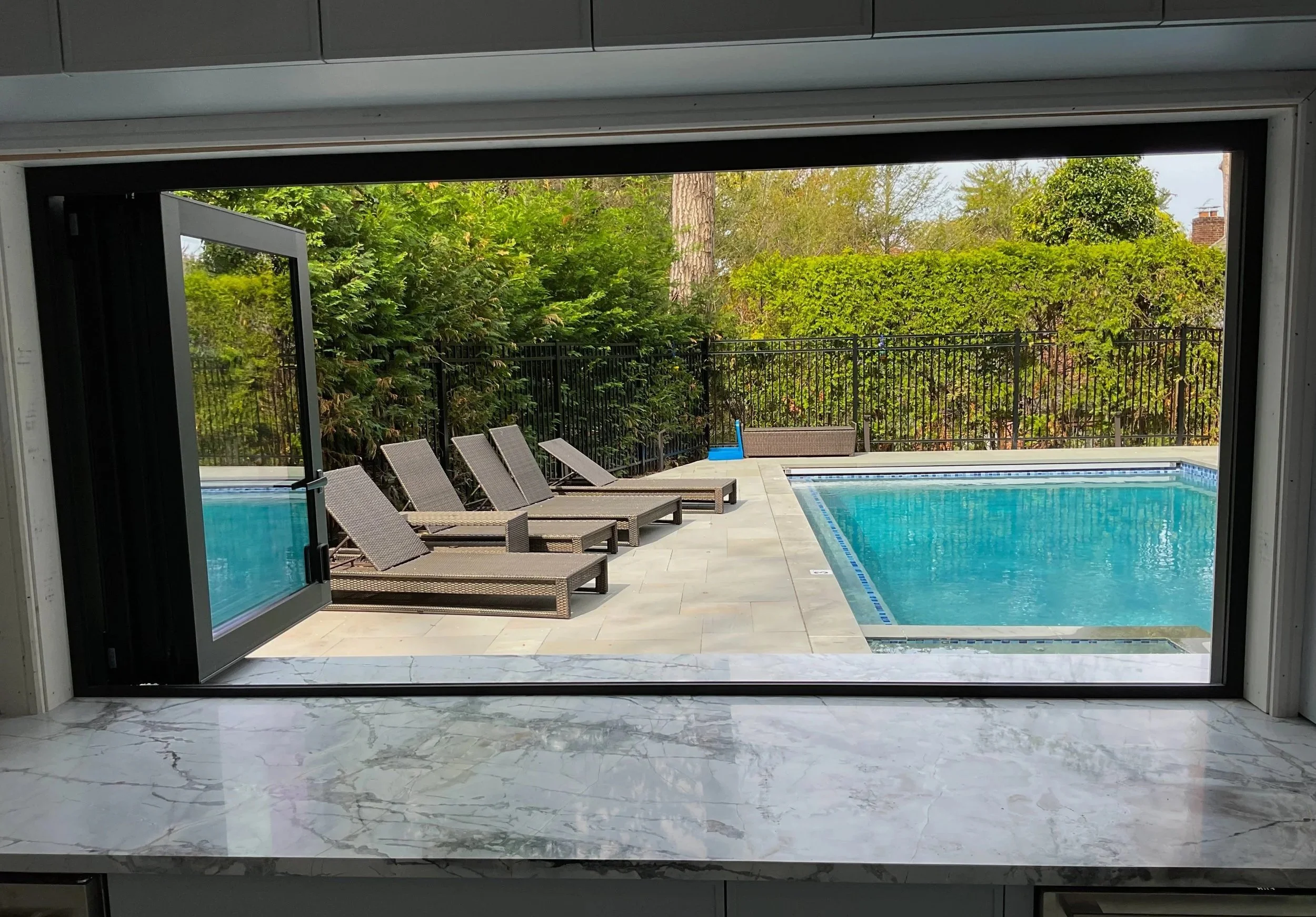 Pool house marble countertop bar installation by Intermarble. Manhasset, New York.
