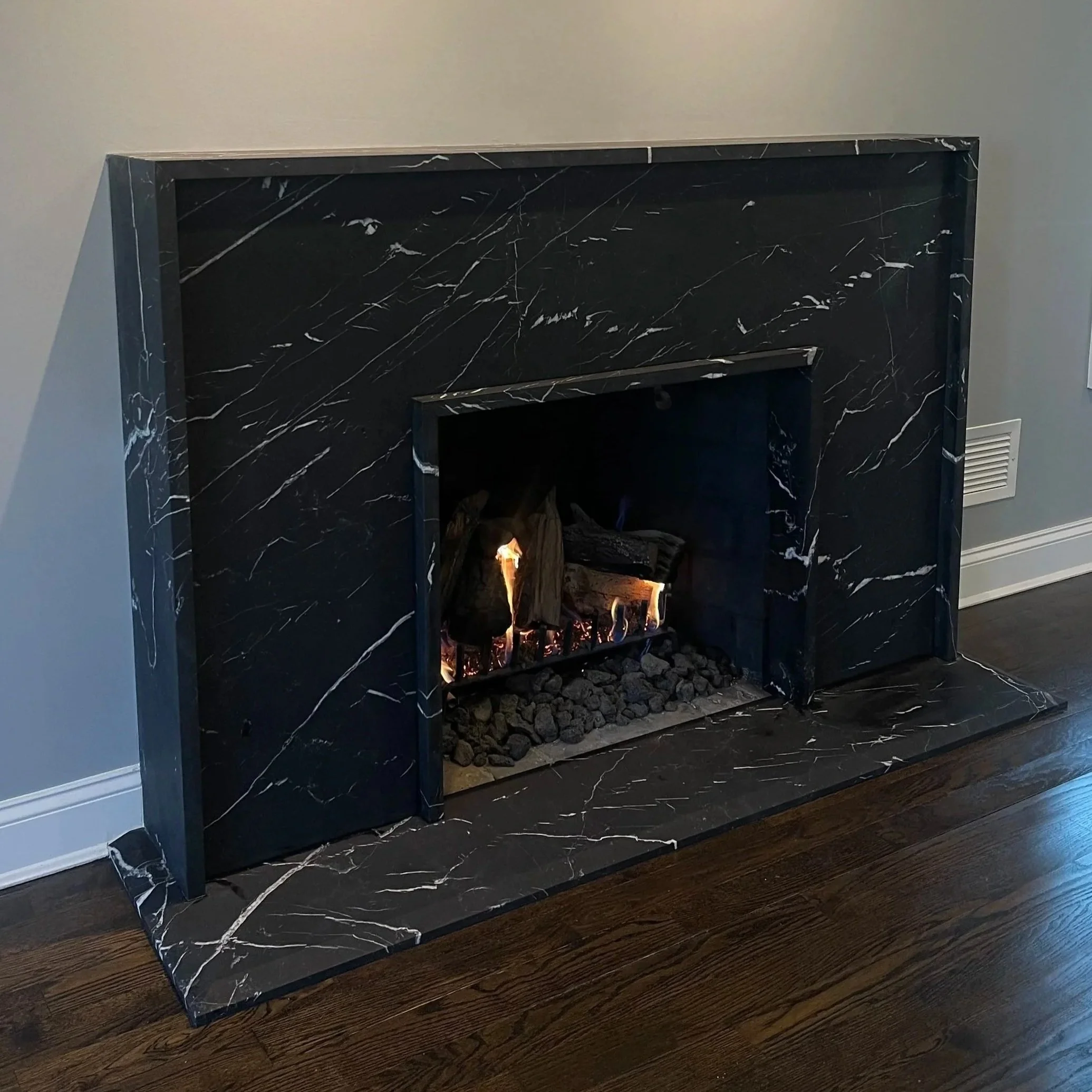 Honed nero marquina modern fireplace in Long Island by Intermarble
