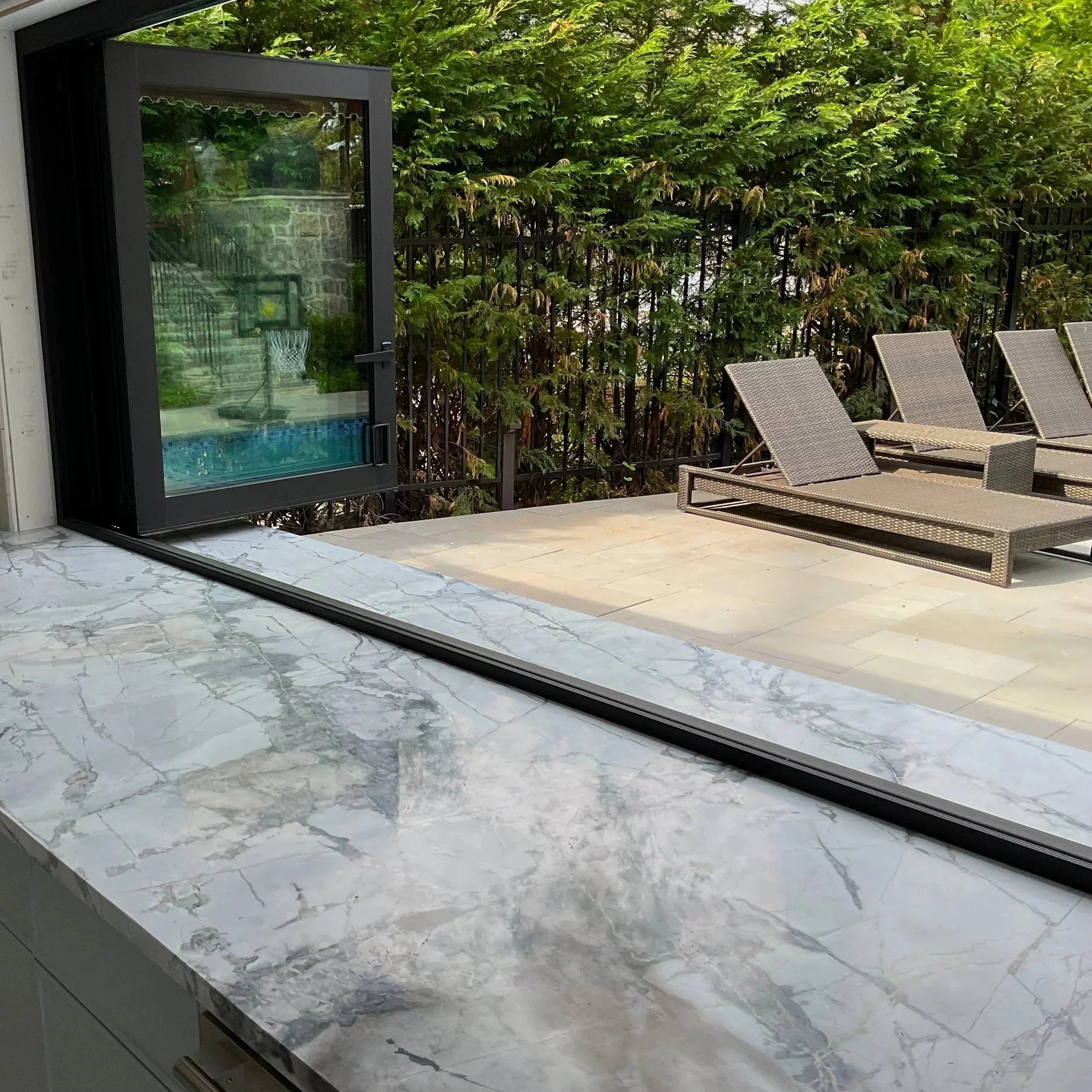 Outdoor pool house stone bar in Sands Point, NY, by Intermarble