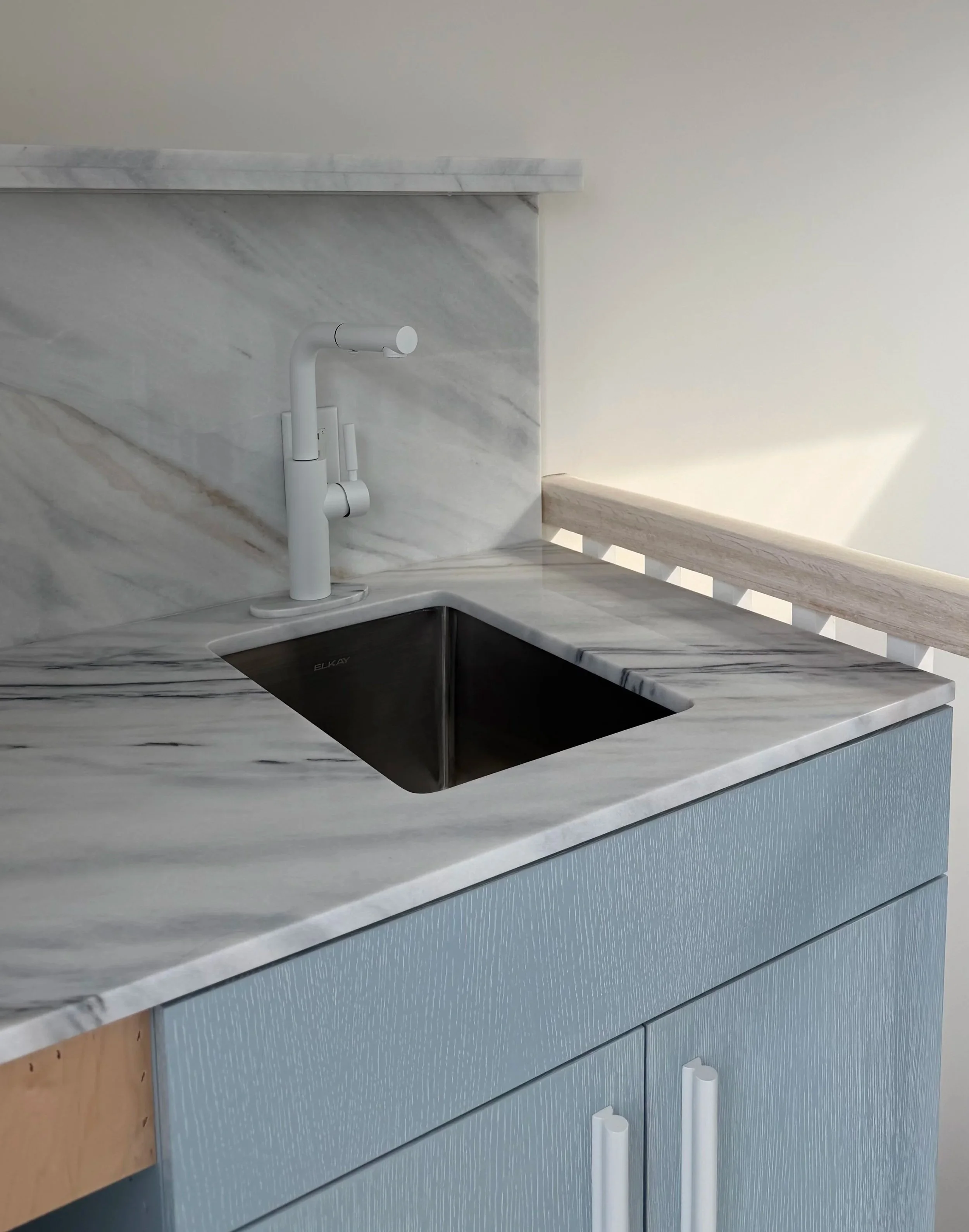Bianco Lasa marble wet bar closeup fabricated and installed by Intermarble for a private residence in West Hampton Beach, NY