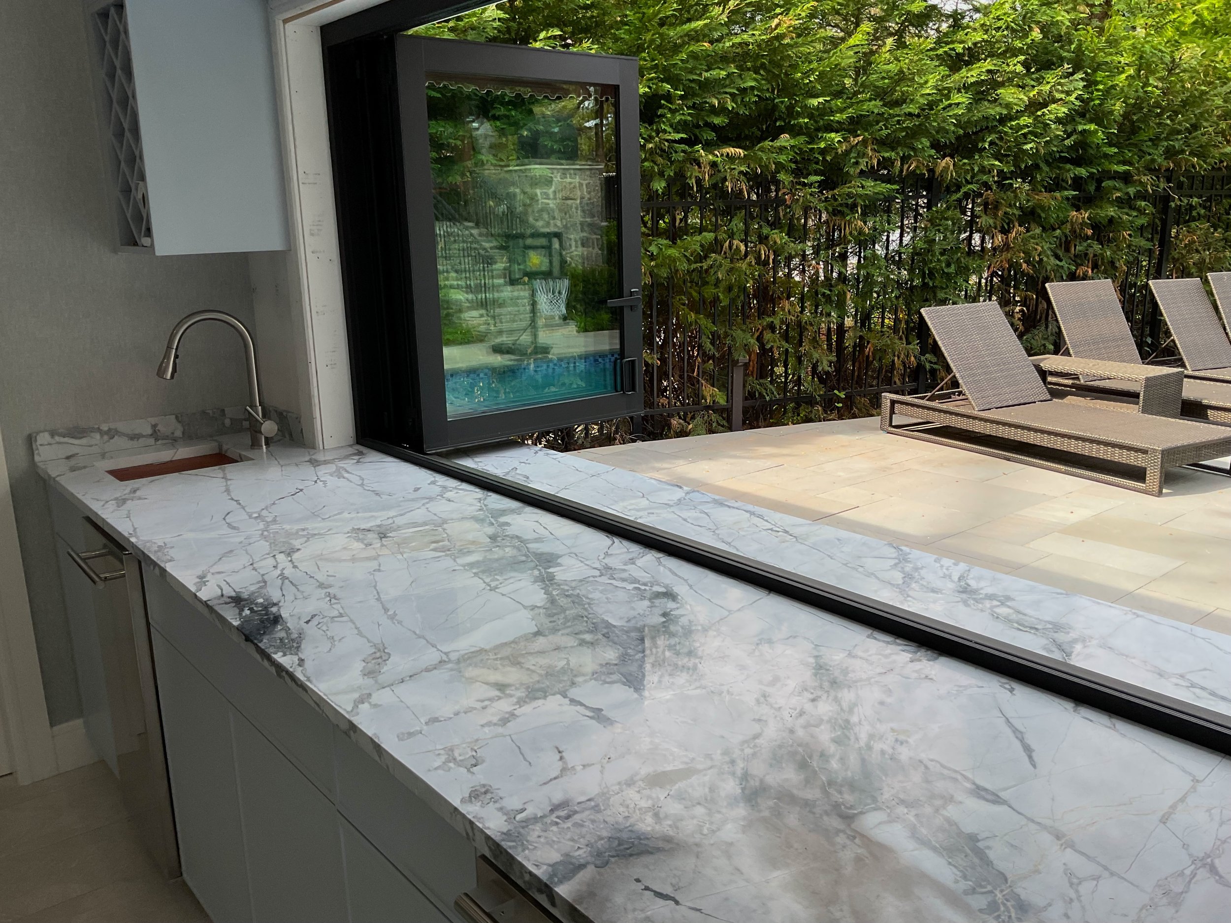 Pool house marble countertop installation by Intermarble. Manhasset, New York.