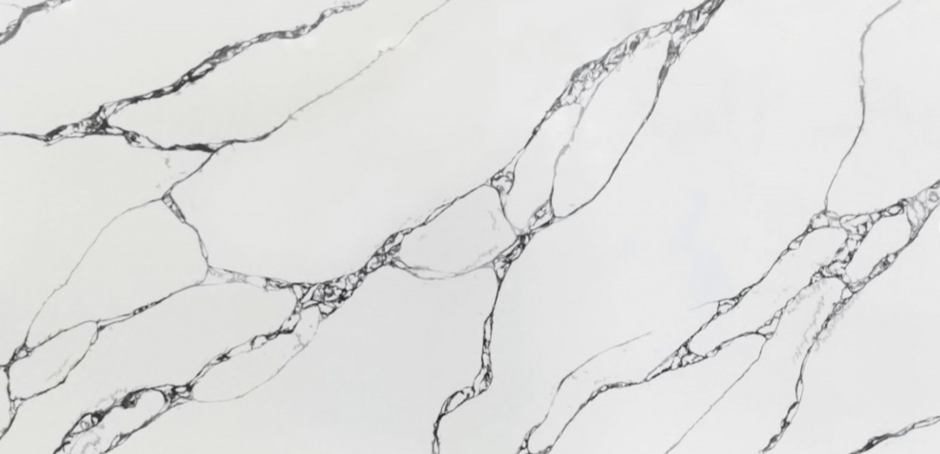 Engineered quartz surface featuring a white base and fine gray veining, known for its durability and uniform appearance.