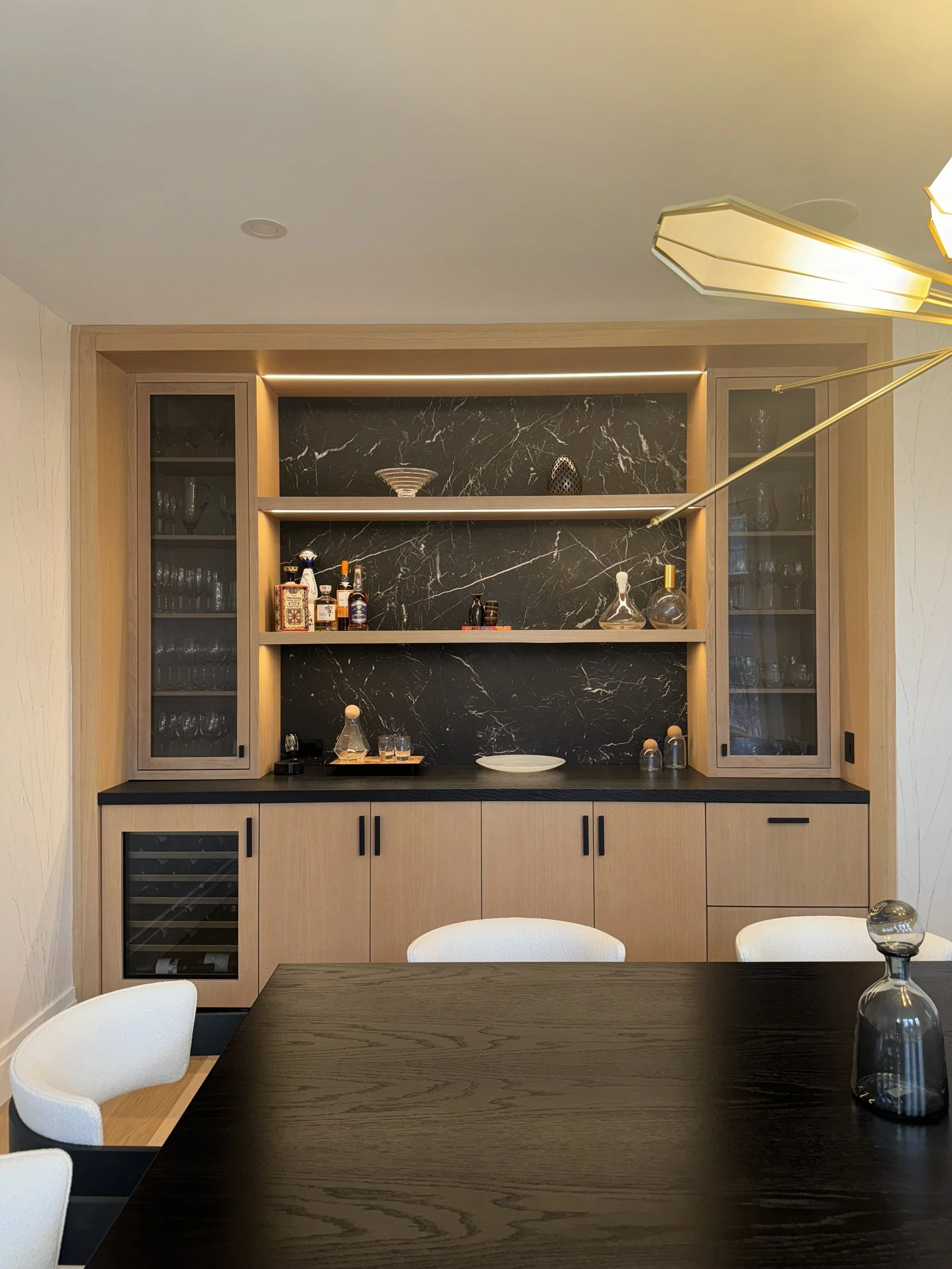 Honed Nero Marquina backsplash and leathered black absolute quartz bart top by Intermarble. Sands Point, New York